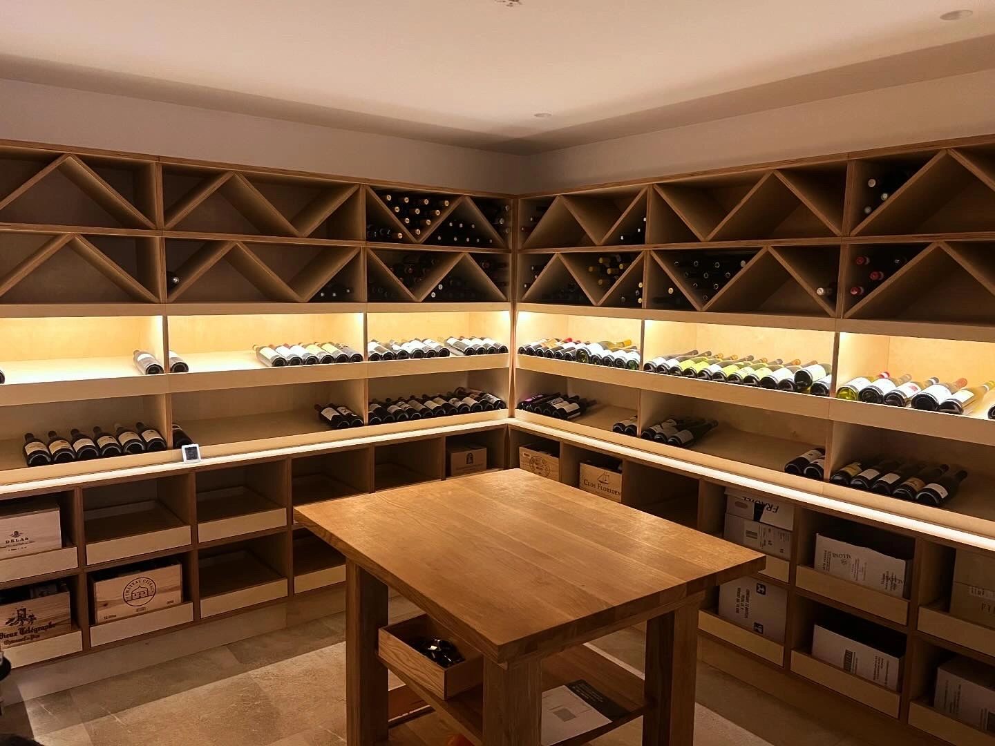 A wine cellar with warm light running under every shelf, from the Cullen Electrical photo gallery