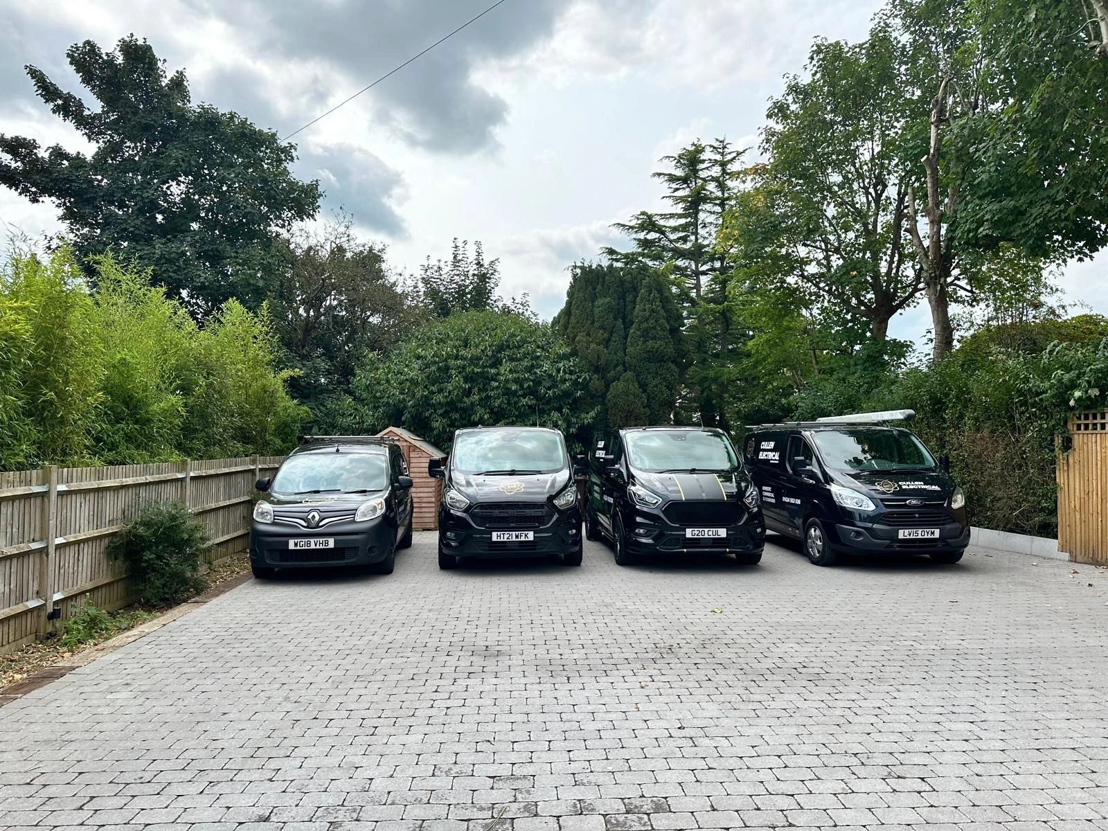 The Cullen Electrical vans lined up on a drive
